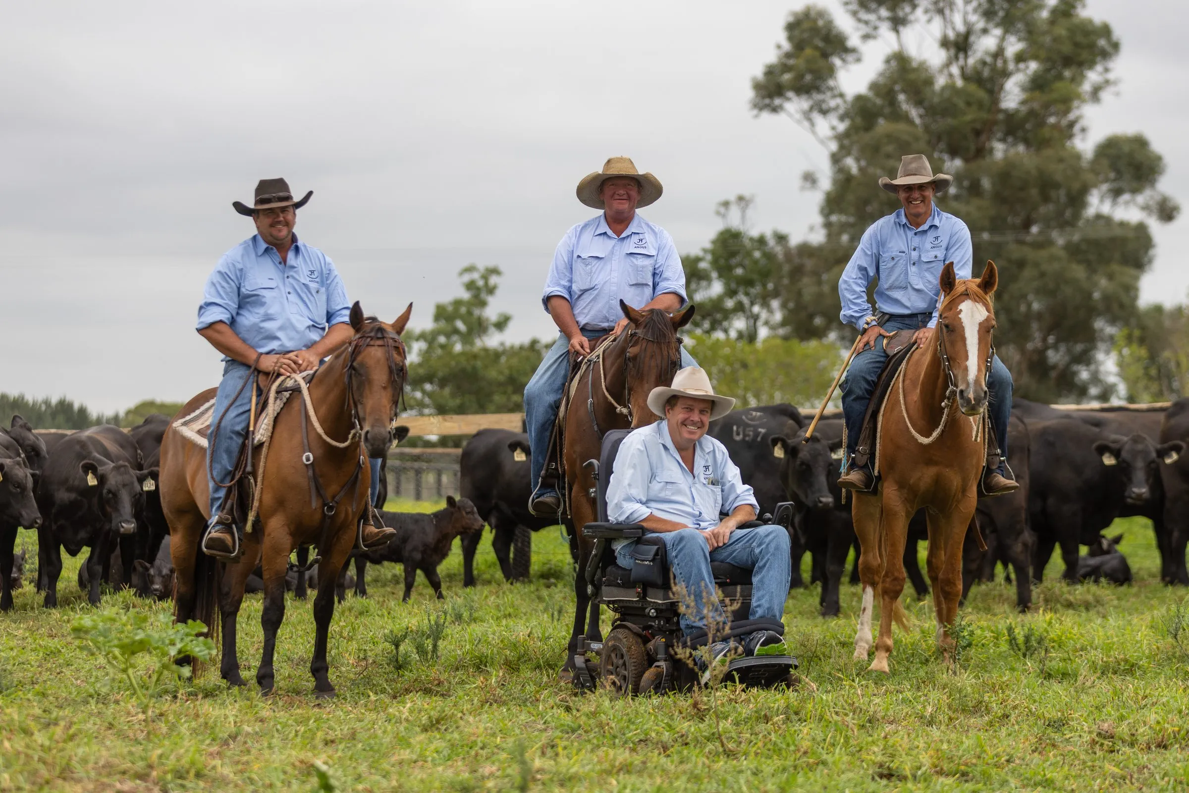 Josh Clift in the paddock with three of the JT Angus crew on horseback